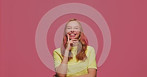 Funny humorous young girl grimacing, fooling around show tongue, comical goofy facial expression, laughing