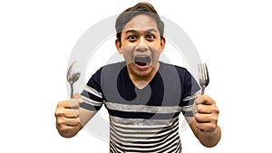 Funny and hungry face expression of young Asian Malay man with strips t-shirt holding a spoon and fork ready to eat