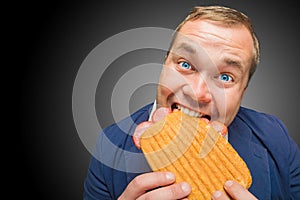 Funny hungry man eating the tasty sandwich