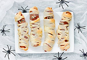 Funny idea for kids for Halloween food - sausage in dough as a m