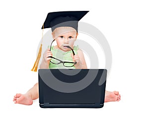 Funny Intelligent Child in Graduation Hat with Computer holding Eyeglasses. Curious Baby using Black Notebook looking at Camera