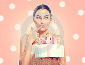 Funny joyful beauty model girl holding big beautiful party or birthday cake over pink background