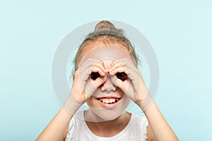 Funny joyful playful girl pretend look binocular photo