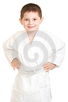 Funny karate kid holding hands on sides
