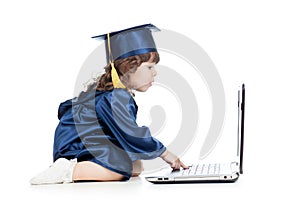 Funny kid in academician clothes using laptop