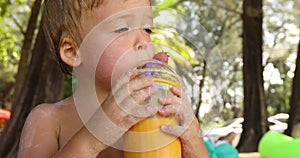 Funny kid drinking fruit fresh in tropics