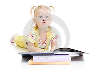 Funny kid in eyeglases reading book isolated photo