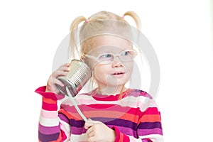 Funny kid in eyeglasses using a can as a telephone