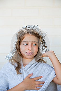 Funny kid girl scared about his dye hair with foil