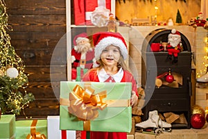 Funny kid holding Christmas gift. The morning before New Year. Christmas kids - happiness concept. Christmas kids.