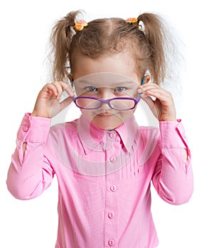 Funny kid putting on spectacles isolated photo