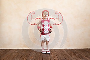 Funny kid sportsman holding dumbbell