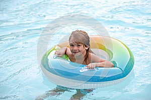 Funny kid in swimming pool. Child summertime holiday vacation. Boy at swimmingpool. Childhood.