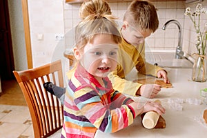 Funny kids bake cookies in kitchen. happy family