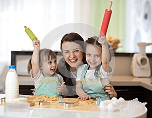 Funny kids baking cookies with her mother