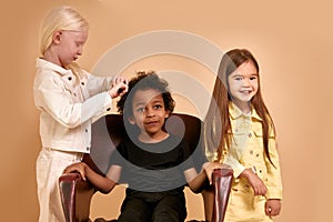 Funny kids combing hair to each other