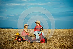 Funny kids. Happy children farmers cycling and having fun on field. Children farmer in the farm with countryside