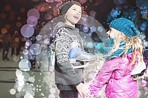 Funny kids holding ice skates shoes at ice rink outdoor