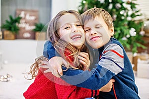 Funny kids are hugging. The boy and the girl. Happy Christmas an