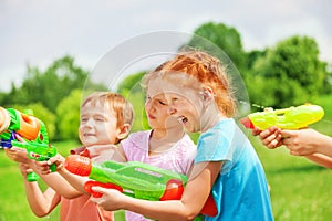 Funny kids playing with water guns