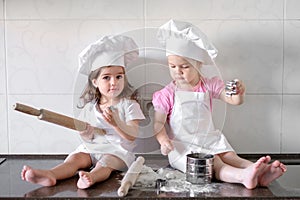 Funny kids are preparing the dough in the kitchen. happy family