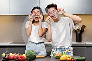 Funny Korean Couple Cooking Having Fun With Vegetables In Kitchen
