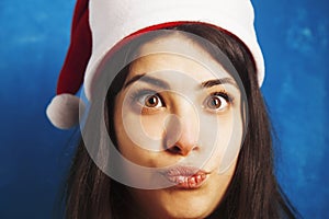 Funny Laughing Christmas girl with red fluffy Santa Hat New Yea