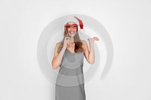 Funny laughing Santa girl wears pretend hearts glasses isolated on white background New Year party