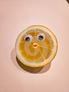 Funny lemon with cartoon eyes on isolated background