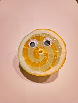 Funny lemon with cartoon eyes on isolated background