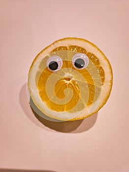 Funny lemon with cartoon eyes on isolated background