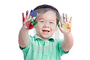 Funny little boy with hands painted in colorful paint. Isolated on white background.