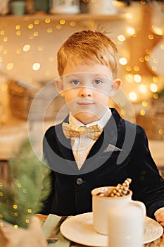 a funny little boy in a jacket and bow tie