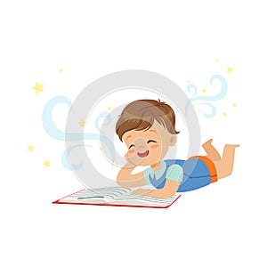 Funny little boy lying and reading magic book with fantasy stories. Interesting childhood and imagination concept