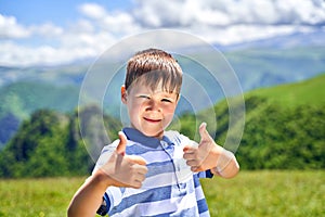 a funny little boy shows the class and smiles