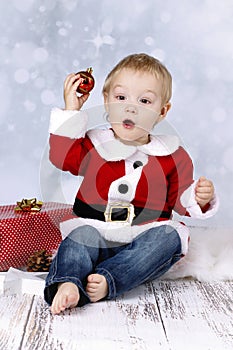 Funny little boy throwing christmas ball