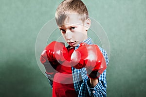 Funny little child with boxer gloves fighting looking dangerous