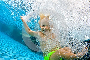 Funny little child dive underwater