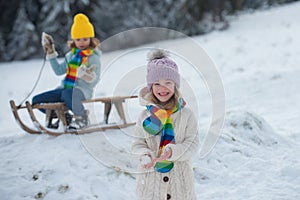 Funny little child girl hold snow ball in winter outdoor in frost snowy winter day outdoor.