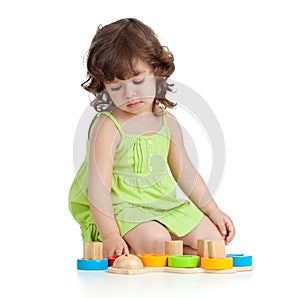 Funny little child playing with colourful toys