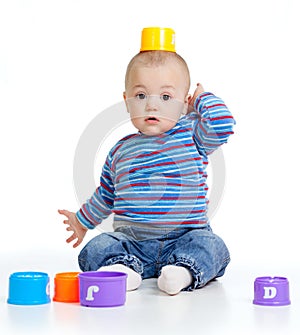Funny little child is playing with cup toys