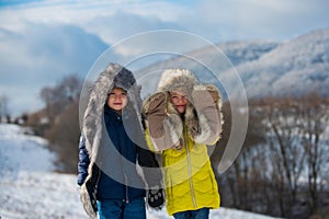Funny little children in winter outdoor. Smiling kids friends in frost snowy day outdoor. Two handsome boys an girl