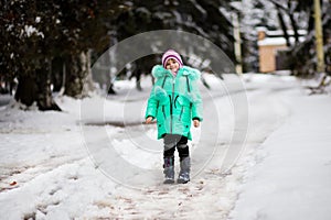 Funny little girl having fun in beautiful winter park