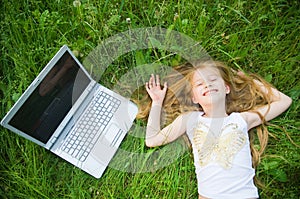 Funny little girl with laptop