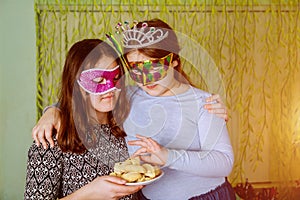 Funny little girl with mask at kids Jewish holiday Purim