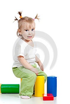 Funny little girl playing with colorful toys