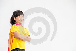 Funny little girl playing power superhero over white background. superhero concept