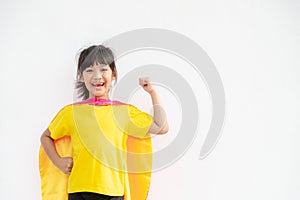 Funny little girl playing power superhero over white background. superhero concept