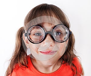 Funny little girl in round glasses