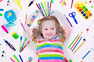 Funny little girl with school supplies